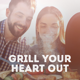 Young couple looking at food on a grill.