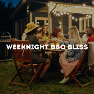 Group of family and friends sitting around a table in the backyard eating food in the evening, with a grill and house in the backyard.